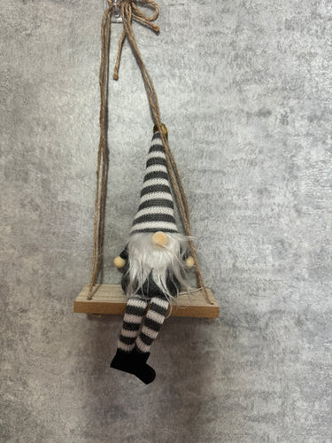 Grey Gonks sitting on a swing