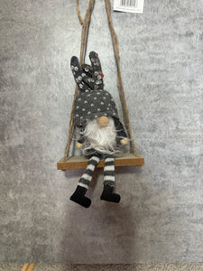 Grey Gonks sitting on a swing